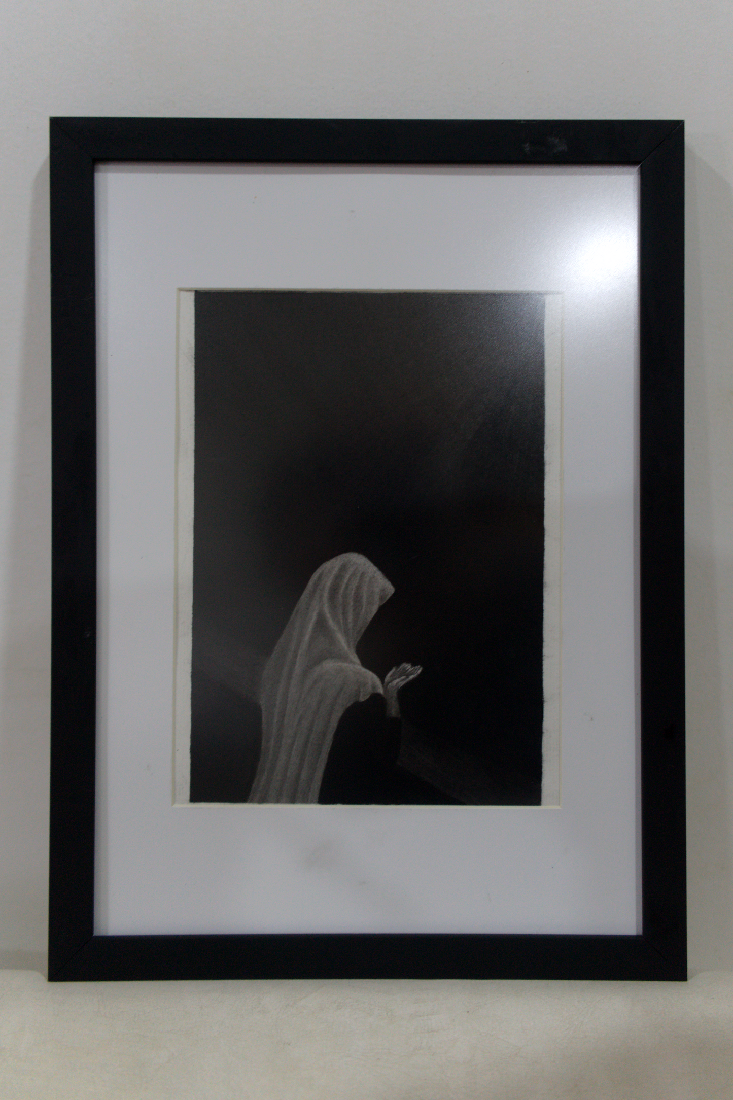 A woman praying (framed)
